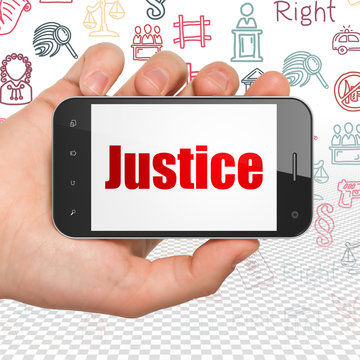 Law concept: Hand Holding Smartphone with Justice on display