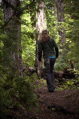 Obraz premium Woman Hiking Through The Woodland Wilderness