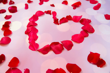 close up of red rose petals in heart shape