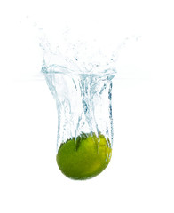 Fototapeta na wymiar lime falling or dipping in water with splash