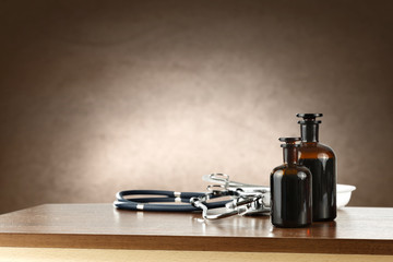 Obraz na płótnie Canvas wooden desk top and doctor tools 