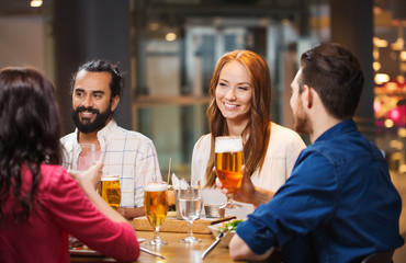 friends dining and drinking beer at restaurant