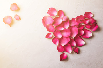 Heart shape of pink rose petals on cement floor, Vintage photogr