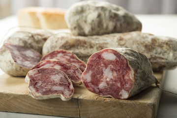 Italian sausages arranged on a cutting board, selective focus.