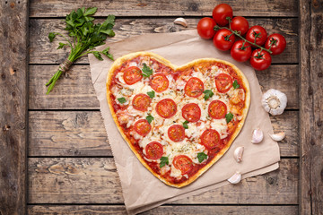 Valentines day heart shaped pizza margherita vegetarian love concept with mozzarella. tomatoes,...