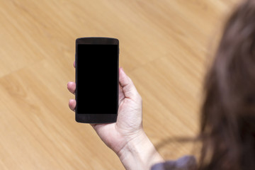 Smart phone holding in female hand.