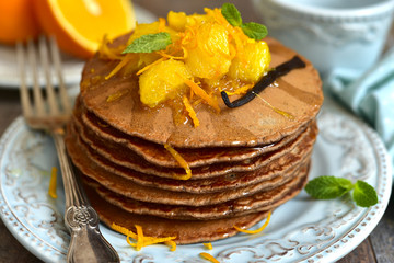 Chocolate pancakes with oranges.