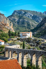 Obraz premium Bar, Montenegro - September 28, 2012: Medieval Bar aqueduct and mountain range on background on a sunny day. 