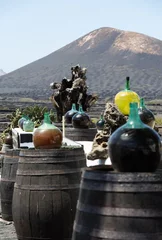 Poster Barrels and  big bottles with grape wine - malvasia.  Lanzarote, Spain © wjarek