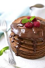 Chocolate pancakes with raspberry and chocolate sauce