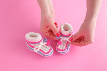 woman carefully adjusts the strings on booties
