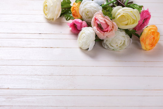 Border from flowers  on white wooden background.