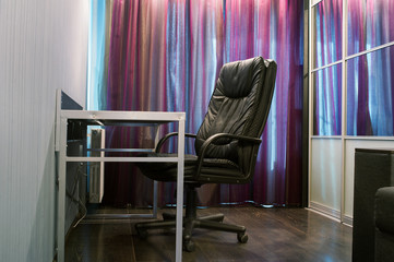 Black leather armchair with table. Business concept