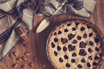 Homemade cherry pie on rustic background