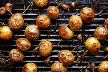 Baked baby potatoes in the form skewers on grill pan