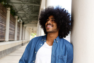 Smiling young man with afro laughing