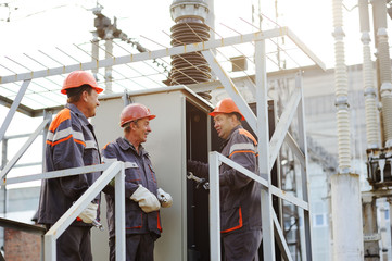 workers repairing power transformer