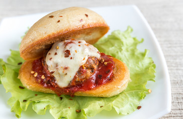 Sandwich with meatball in tomato sauce and mozzarella