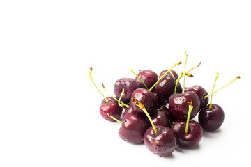 a small group of cherries arranged in a white background