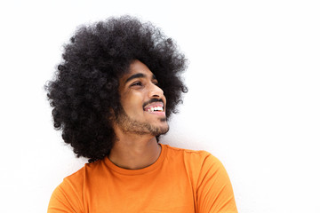 Smiling young man with cool hair looking away