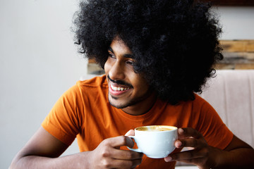 Afro man drinking cup of coffee