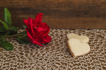 Red rose and cookies on a table. Valentine's day