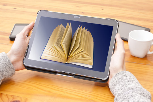 hands with tablet and digital book