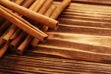 Cinnamon on a brown wooden background