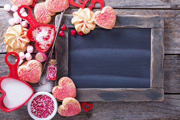Valentines day cookies around a chalkboard © fahrwasser
