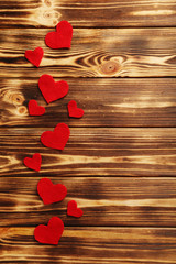 Red hearts on a brown wooden table
