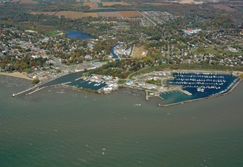 aerial view from above Lake Erie towards the town of Port Dover, Ontario; view of the Marina and Lighthouse