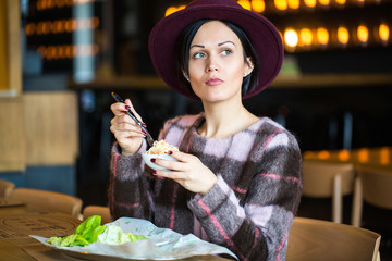 beautiful young girl eating salad at cafe