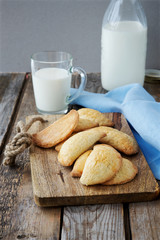 Pies and milk on a wooden background 