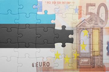 puzzle with the national flag of estonia and euro banknote