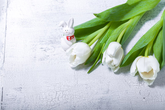 White tulips on a wooden table