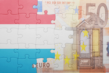 puzzle with the national flag of luxembourg and euro banknote