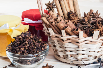 spices in a wicker basket and jars with jam