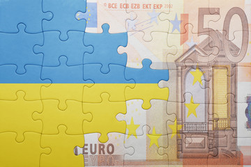 puzzle with the national flag of ukraine and euro banknote