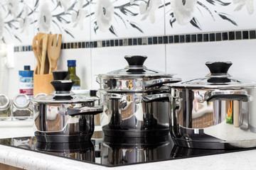 Modern induction cooker with the silver pots