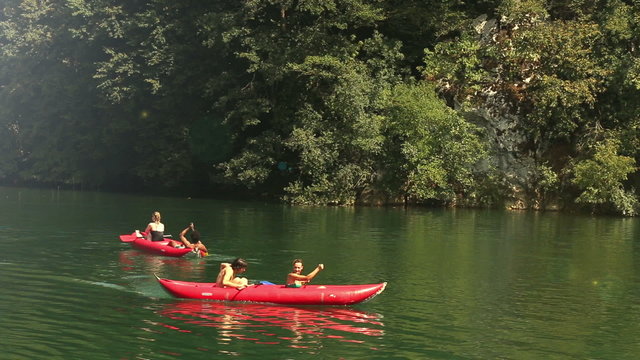 Friends enjoying riding canoe on river