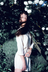 Portrait of young beautiful woman, on green background summer nature.