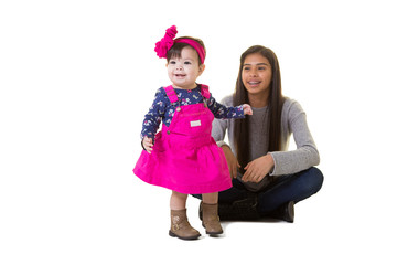 A teenager holding her baby sister