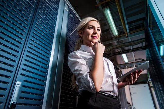 Young engineer businesswoman in server room