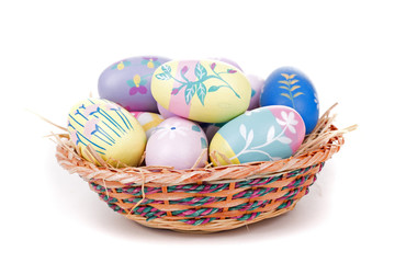 Fototapeta na wymiar Colorful Easter Eggs in a Basket on a White Background