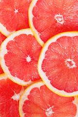 Juicy grapefruit slices as a colorful background