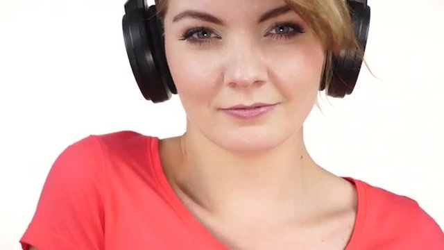 Woman in big headphones listening music closeup 4K