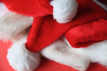 Obraz na płótnie Canvas Several Santa Claus hats tossed in a pile