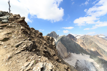 Summit cross on mountain Säulkopf and glacier panorama in Hohe Tauern Alps, Austria