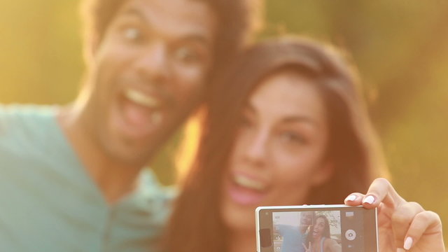 Young, beautiful couple taking a funny selfie