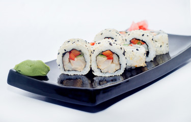 sushi rolls with wasabi and ginger cheese with salmon, tobiko, flying fish game and sesame.